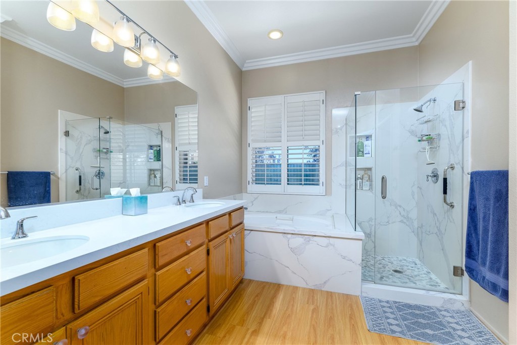 41783 Niblick Road Temecula, CA 92591 - Photo 32 of 33 a bathroom with a sink a toilet a large mirror and shower