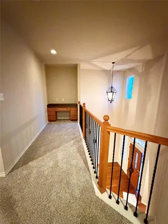 a view of a hallway with stairs