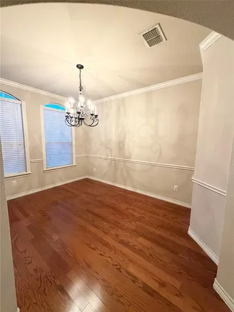 a view of a room with wooden floor