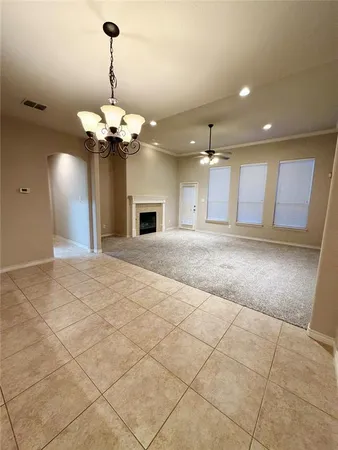 a view of a kitchen with a sink and chandelier fan
