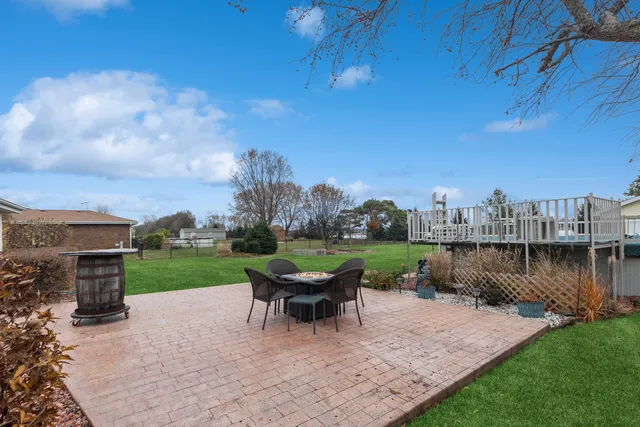 a roof deck with table and chairs a barbeque