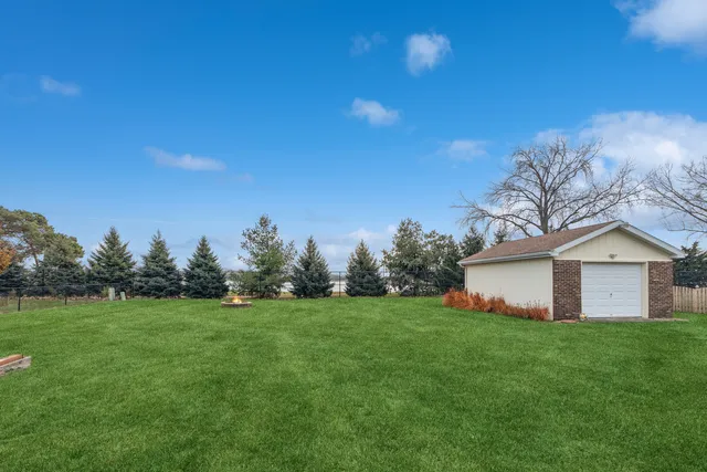 a view of a house with a yard and sitting area