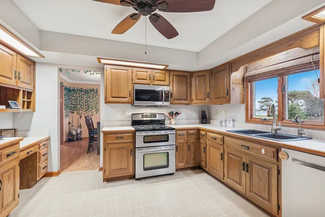 a kitchen with stainless steel appliances a stove sink microwave and cabinets