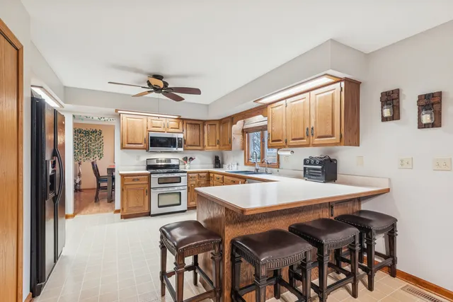 a kitchen with a table chairs stove and refrigerator