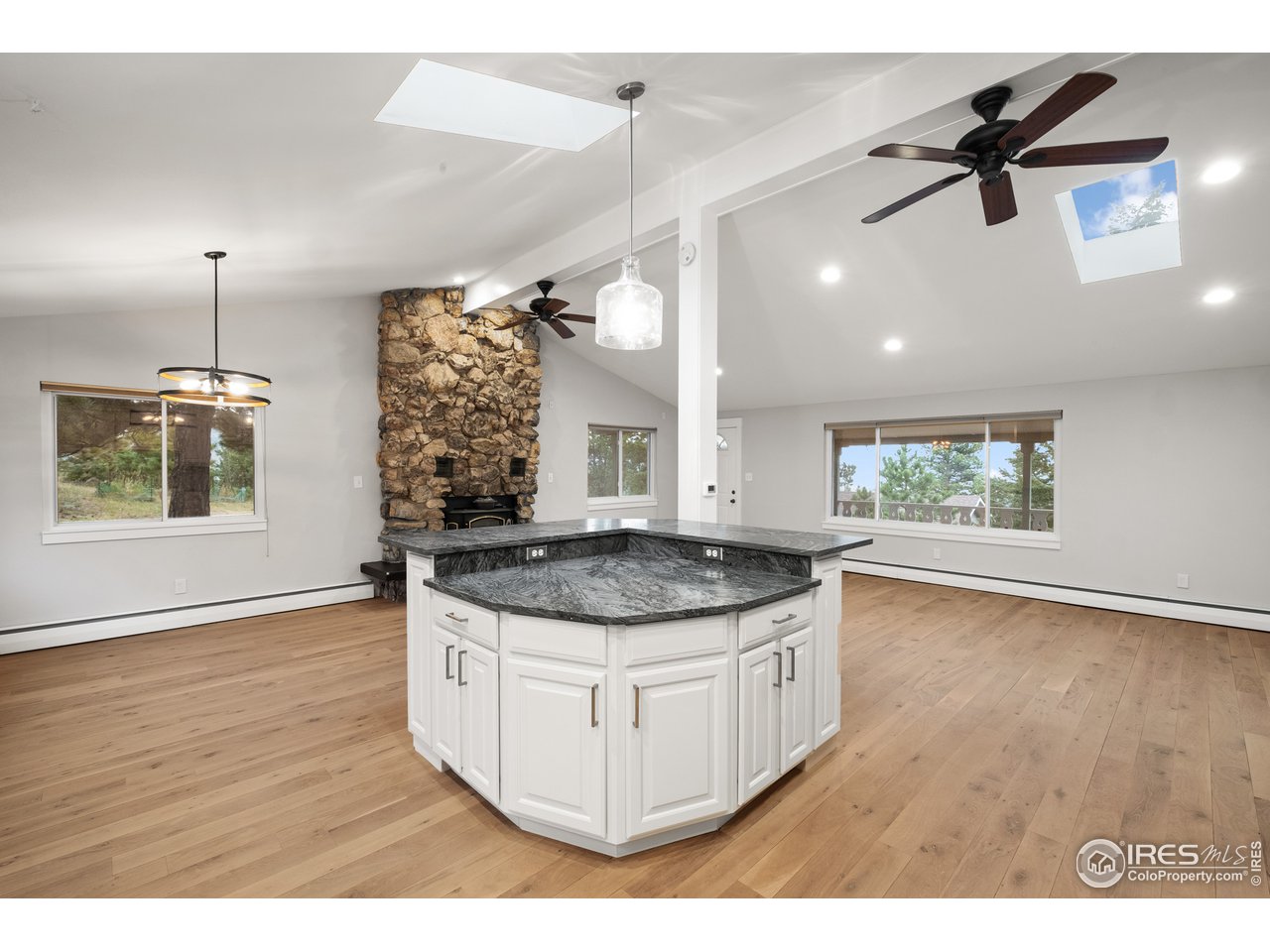1073 Deer Trail Road Boulder, CO 80302 - Photo 10 of 32 a kitchen with a stove and a wooden floor