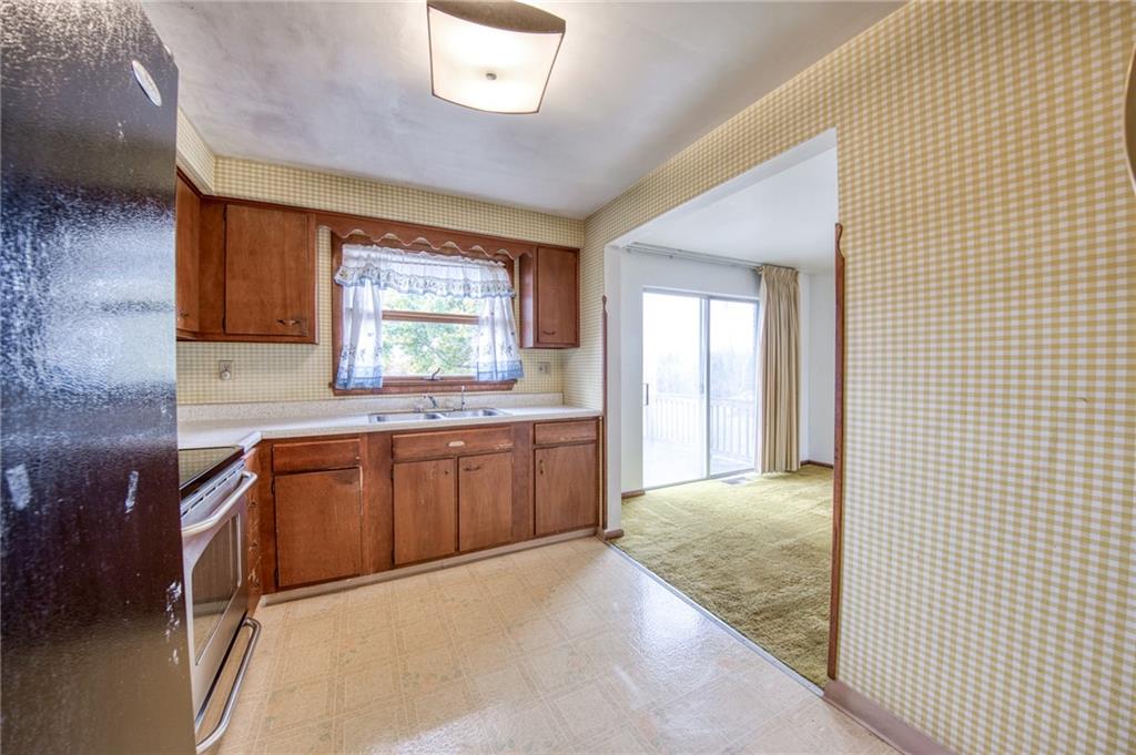 219 Center New Texas Road Pittsburgh, PA 15239 - Photo 30 of 35 a kitchen with stainless steel appliances granite countertop a sink a stove cabinets and wooden floor