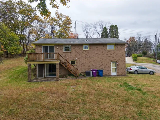 a view of a house with a yard and sitting area
