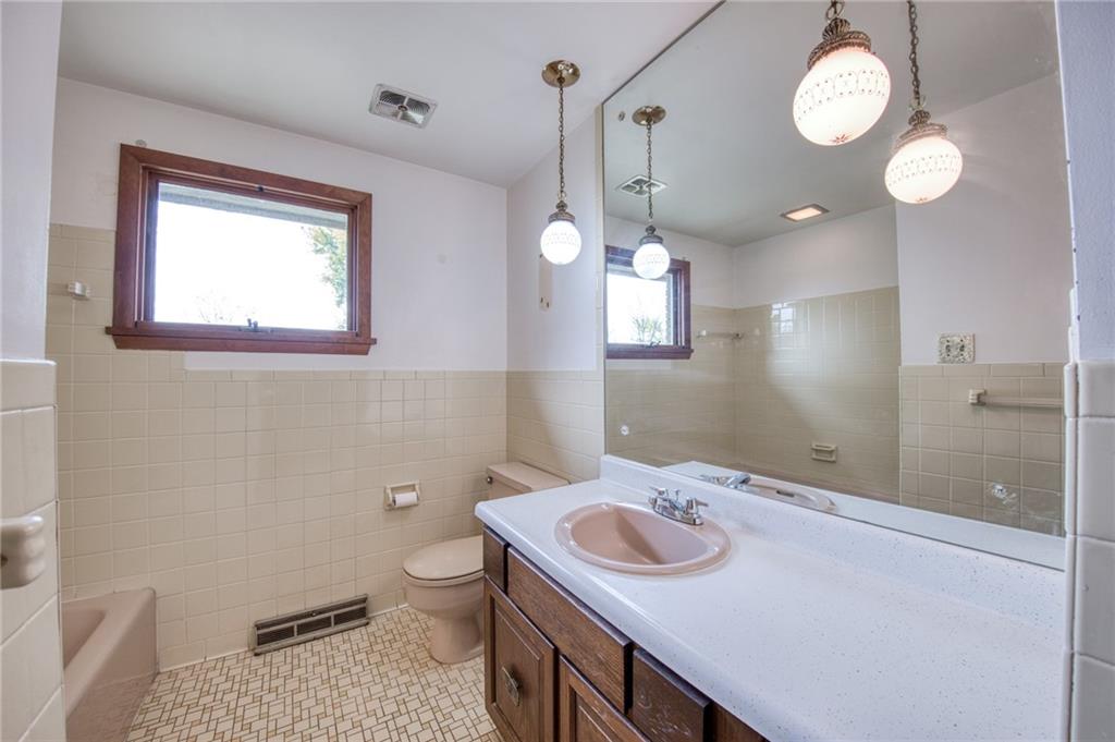 219 Center New Texas Road Pittsburgh, PA 15239 - Photo 31 of 35 a bathroom with a sink a toilet and a mirror