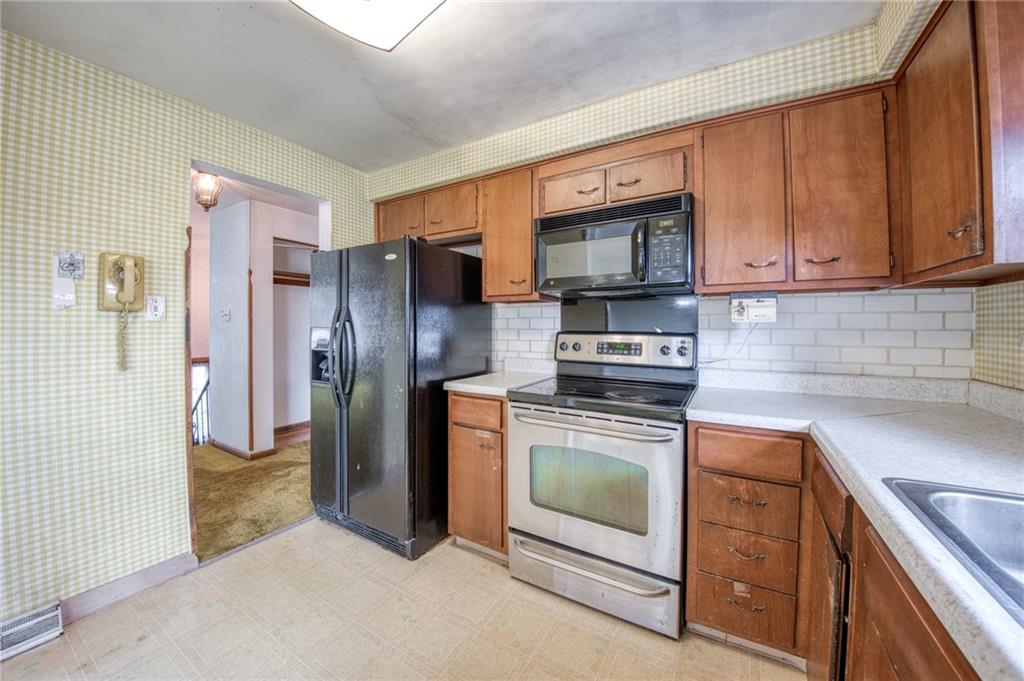 219 Center New Texas Road Pittsburgh, PA 15239 - Photo 6 of 35 a kitchen with stainless steel appliances granite countertop a refrigerator stove and sink