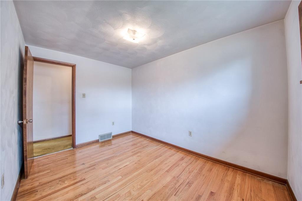 219 Center New Texas Road Pittsburgh, PA 15239 - Photo 9 of 35 a view of an empty room with wooden floor and a window