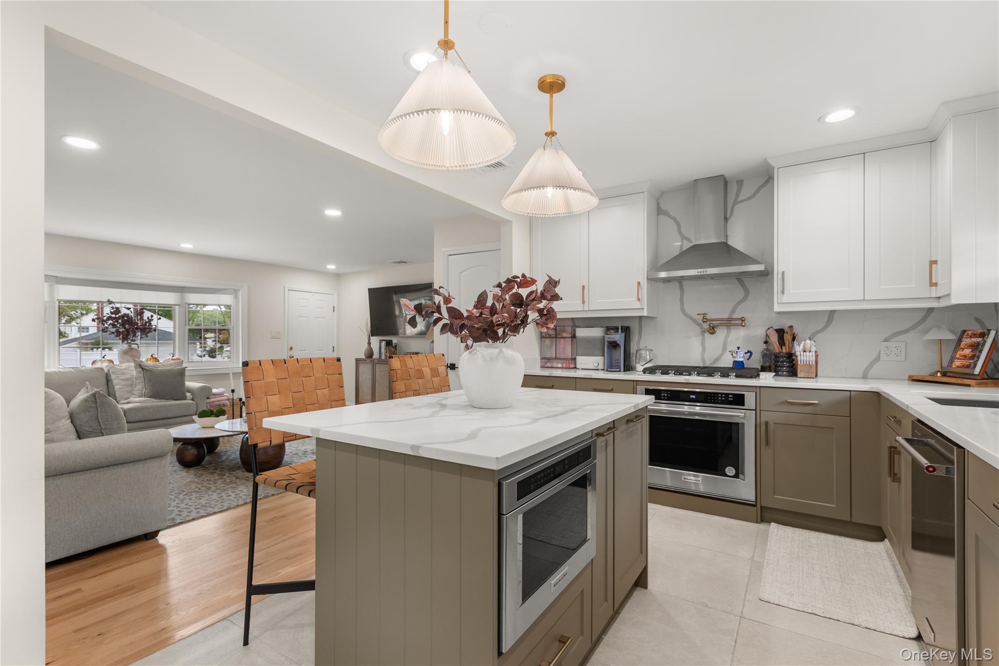 205 Timber Point Road East Islip, NY 11730 - Photo 16 of 16 Kitchen featuring recessed lighting, open floor plan, backsplash, light stone countertops, and a kitchen island