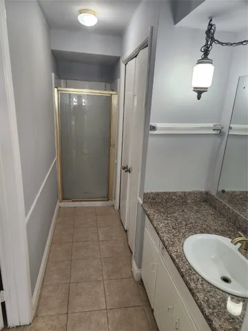 a bathroom with a granite countertop sink and mirror