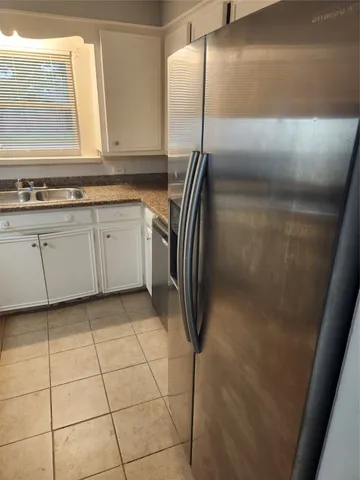 a kitchen with a refrigerator and window