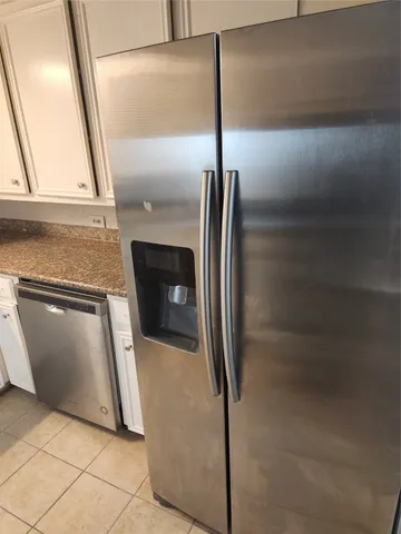 a kitchen with a refrigerator a sink and a stove