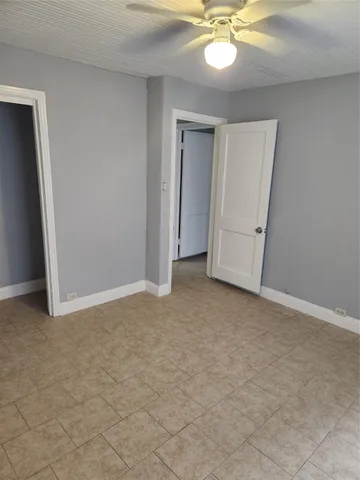 a view of an empty room and a ceiling fan