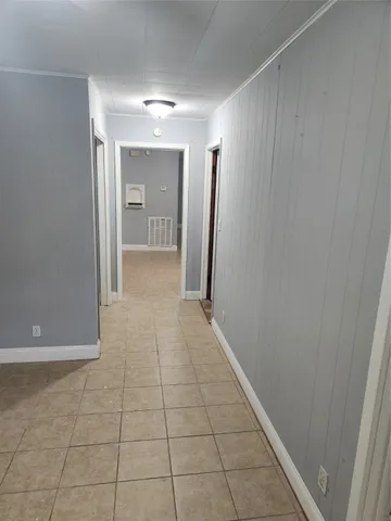 a view of hallway with a window and a refrigerator