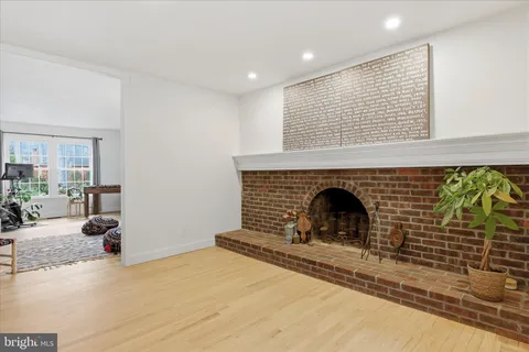 a view of a livingroom with a fireplace and window