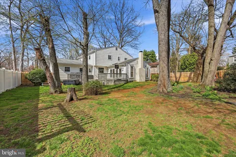 a view of a house with a yard and tree s