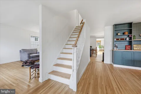 a view of a room with wooden floor and stairs