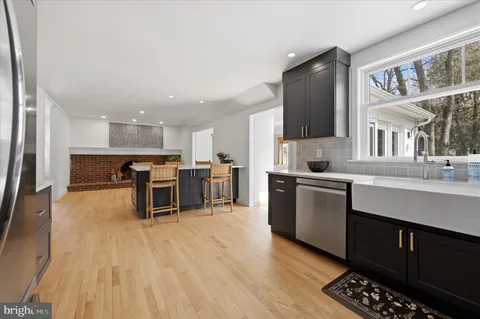 a kitchen with stainless steel appliances kitchen island granite countertop a sink and cabinets