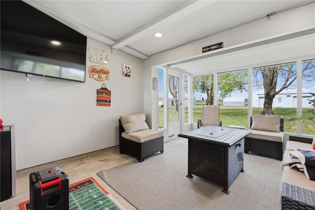 2950 Fairfield Pike Springfield, OH 45502 - Photo 20 of 48 This bright sunroom features expansive windows overlooking a tranquil outdoor setting, perfect for relaxed gatherings.