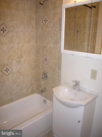 a bathroom with a sink a toilet and bathtub