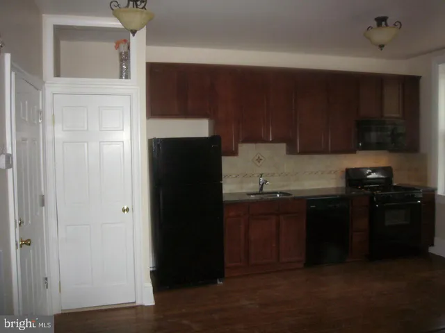 a kitchen with a sink and a refrigerator