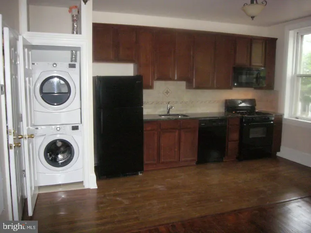 a kitchen with a stove top oven sink and cabinets
