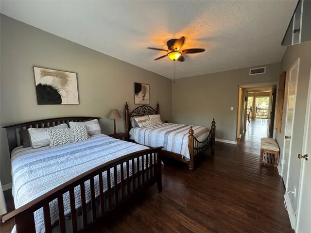a bedroom with a bed window and a chandelier