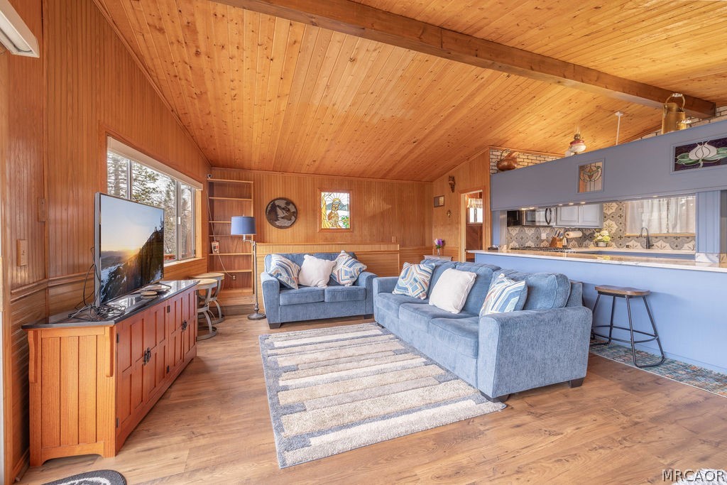 1179 Ridge Road Fawnskin, CA 92333 - Photo 14 of 43 a living room with furniture and a flat screen tv