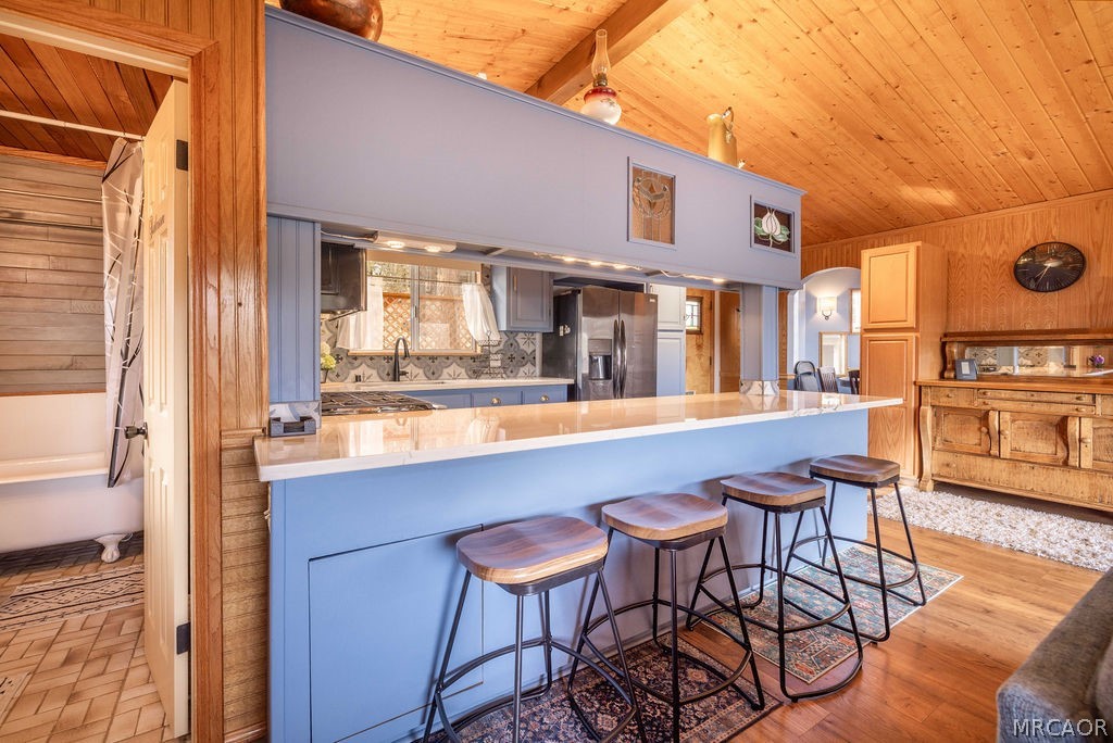 1179 Ridge Road Fawnskin, CA 92333 - Photo 17 of 43 a kitchen with a table chairs and a stove