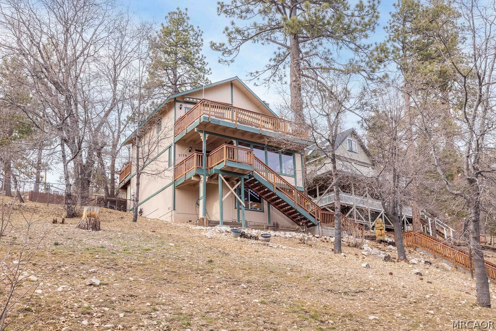 1179 Ridge Road Fawnskin, CA 92333 - Photo 2 of 43 a house that has a tree in front of it
