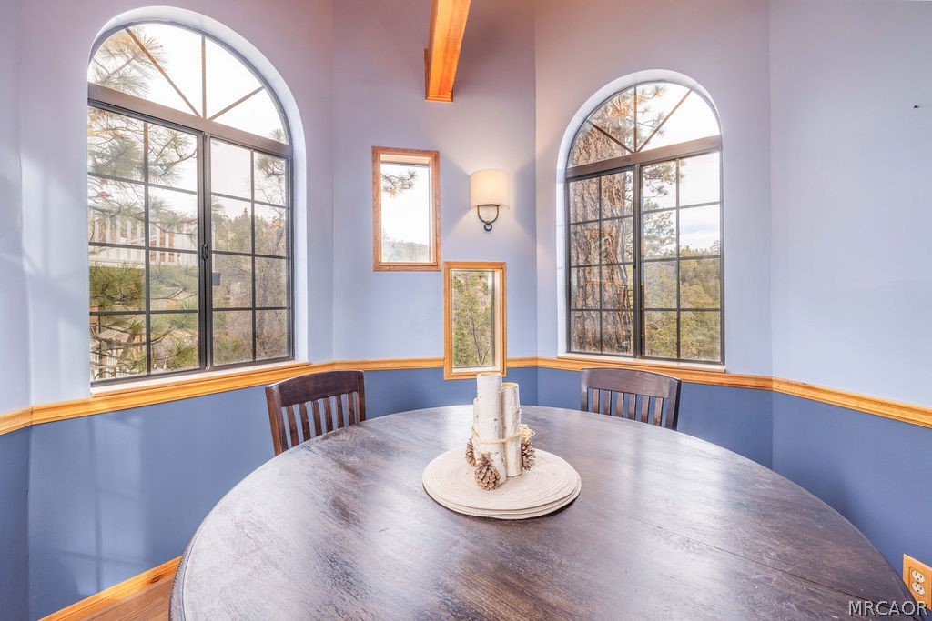 1179 Ridge Road Fawnskin, CA 92333 - Photo 23 of 43 a view of a dining room with furniture and a large window