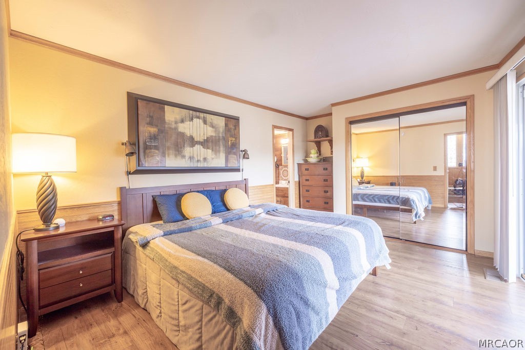 1179 Ridge Road Fawnskin, CA 92333 - Photo 26 of 43 a bedroom with a bed and a night stand