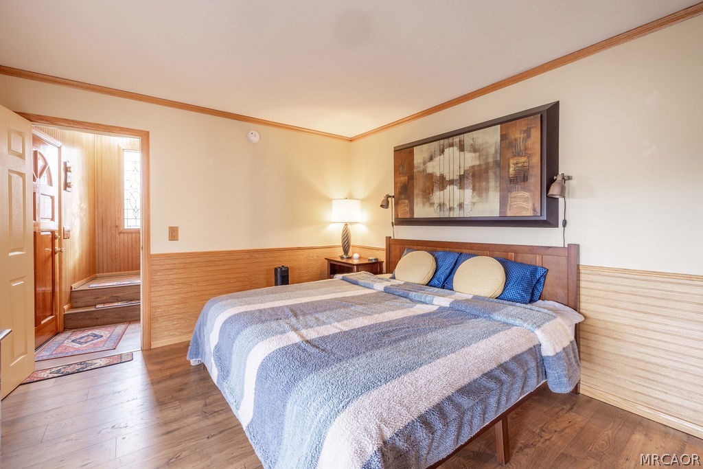 1179 Ridge Road Fawnskin, CA 92333 - Photo 27 of 43 a bedroom with a bed and a painting on the wall