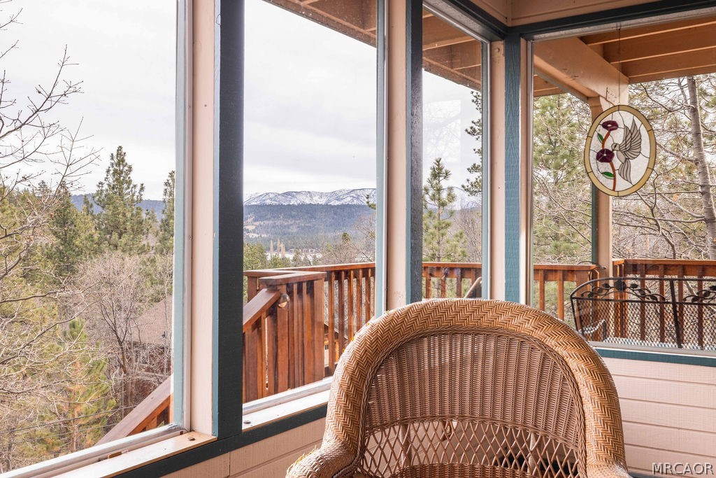 1179 Ridge Road Fawnskin, CA 92333 - Photo 30 of 43 a view of a porch with a table and chairs
