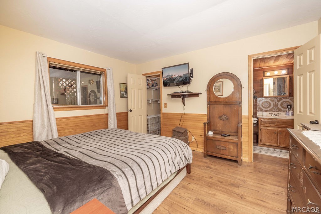 1179 Ridge Road Fawnskin, CA 92333 - Photo 35 of 43 a bedroom with a bed and a large mirror on the dresser