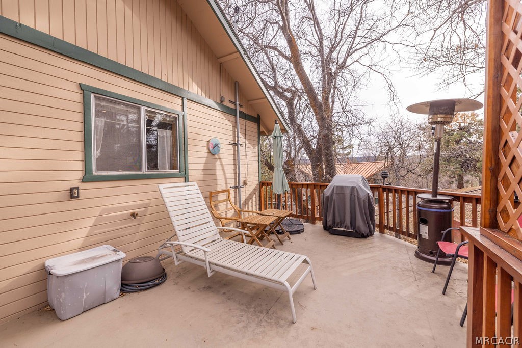 1179 Ridge Road Fawnskin, CA 92333 - Photo 40 of 43 a view of a patio with couches chairs and a fire pit