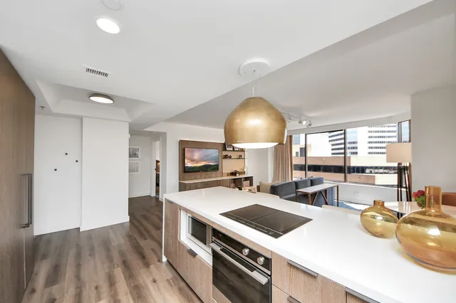 a kitchen with a sink a stove and chairs