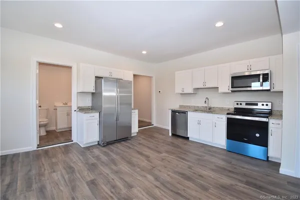 a kitchen with stainless steel appliances a refrigerator sink and microwave