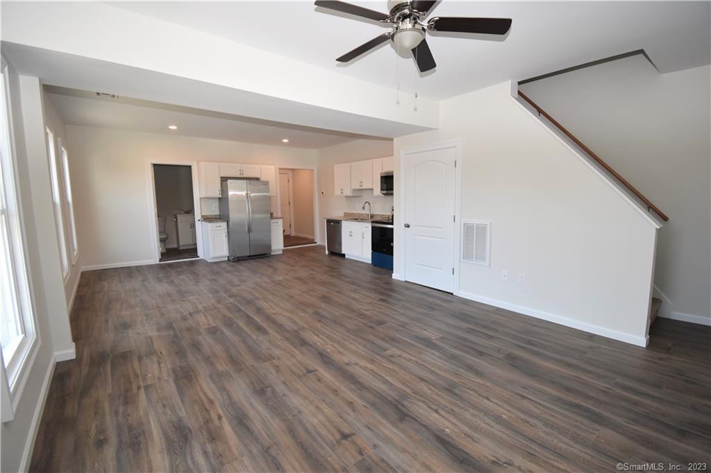 329 Main Street, Unit 3 Plymouth, CT 06786 - Photo 2 of 11 a view of a kitchen with wooden floor and a ceiling fan