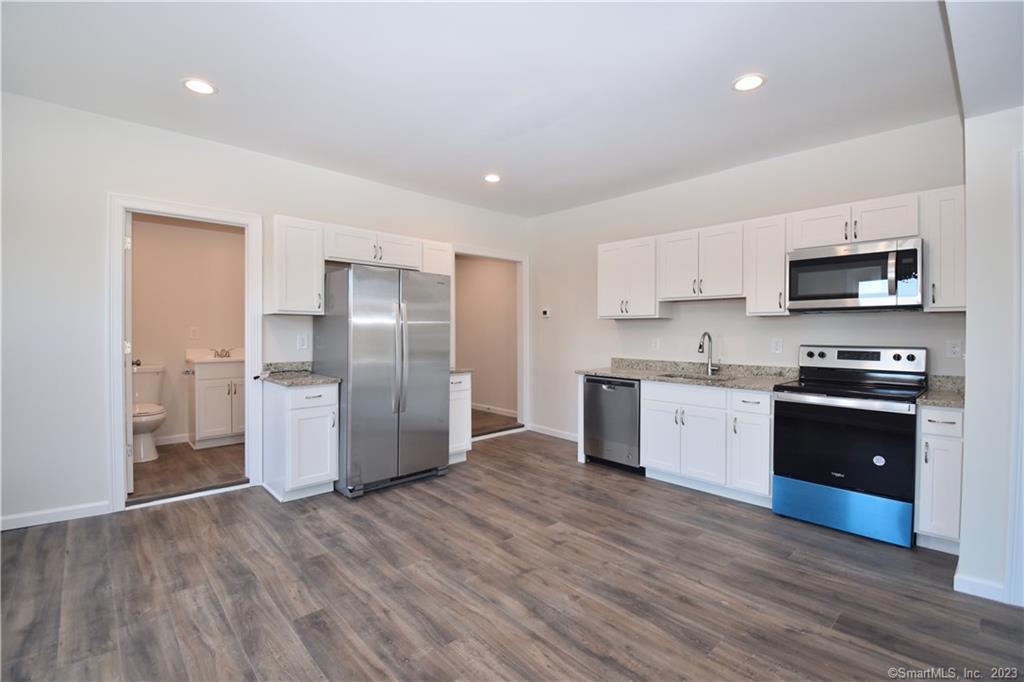 329 Main Street, Unit 3 Plymouth, CT 06786 - Photo 3 of 11 a kitchen with stainless steel appliances a refrigerator sink and microwave