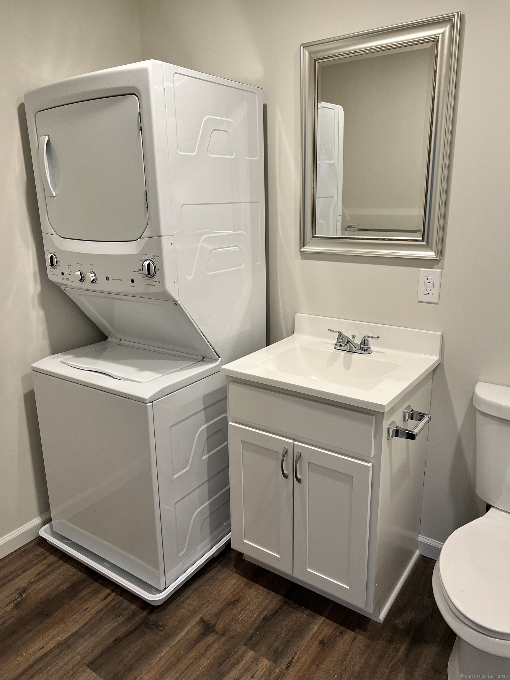 329 Main Street, Unit 3 Plymouth, CT 06786 - Photo 6 of 11 a bathroom with a sink mirror vanity and toilet