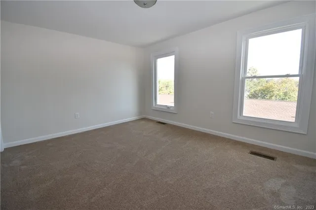 a bathroom with a toilet and a window
