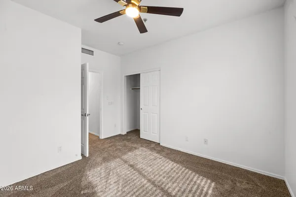 a view of a livingroom with a ceiling fan and wooden floor