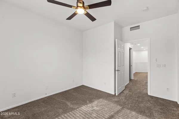 a view of a livingroom with a ceiling fan and window