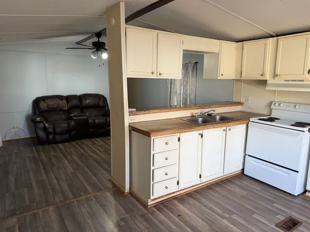 a kitchen with a cabinets and wooden floor