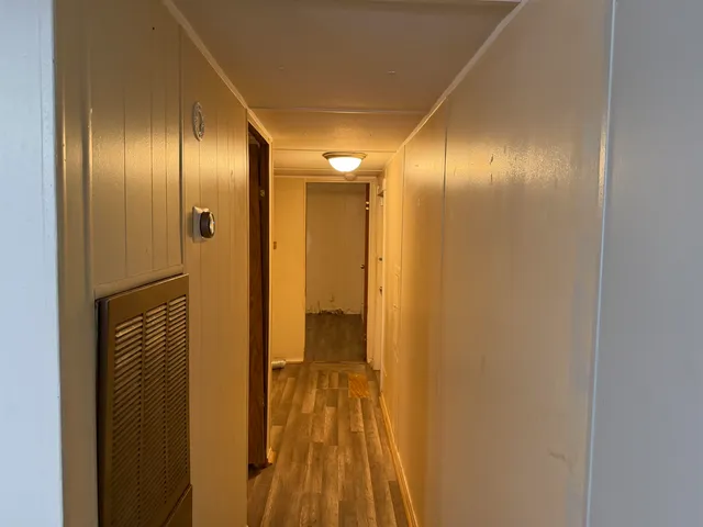 a view of a room with wooden floor