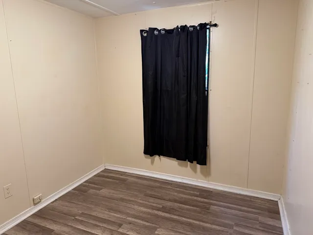 an empty room with wooden floor