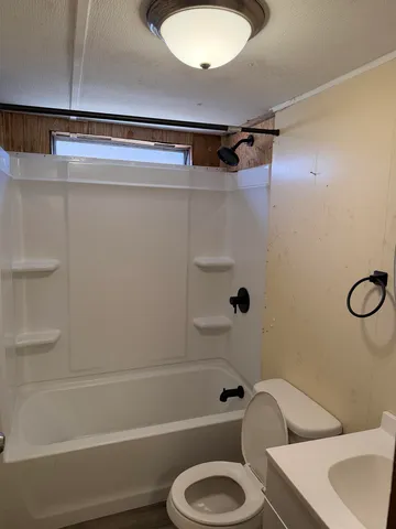 a bathroom with a toilet and a tub